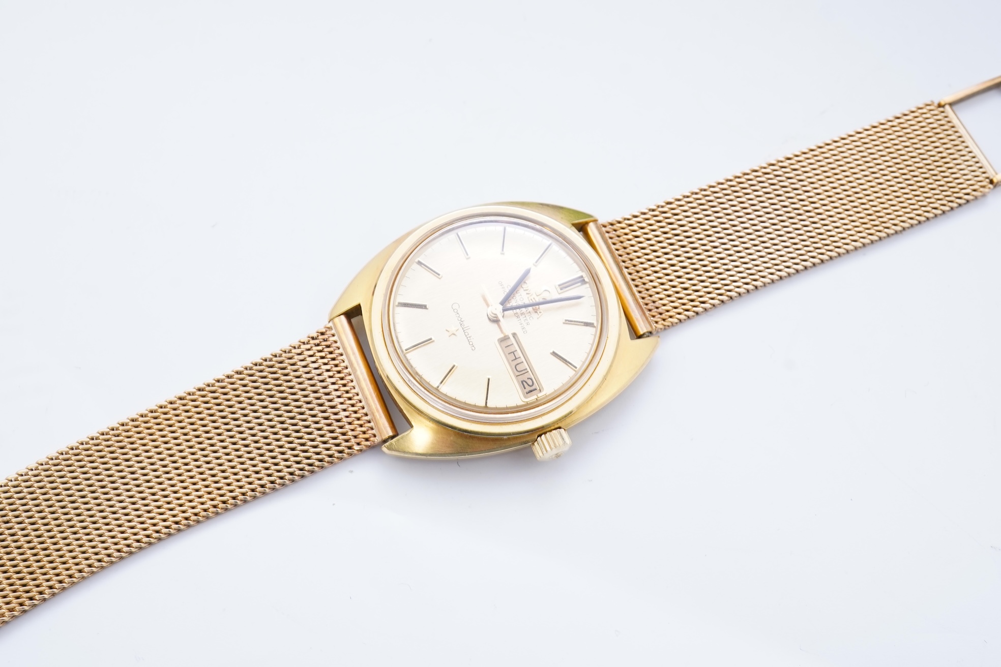 A gentleman's late 1960's 18ct gold Omega Constellation Automatic Chronometer Officially Certified wrist watch, on an associated 9ct gold mesh link bracelet